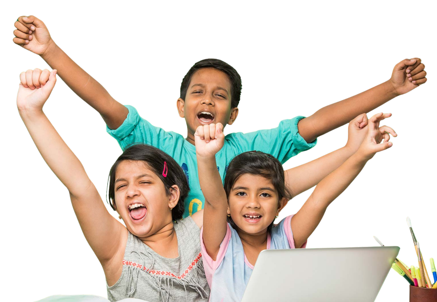 Three cheerful Aum School students raising their arms in celebration at a desk with books and a laptop